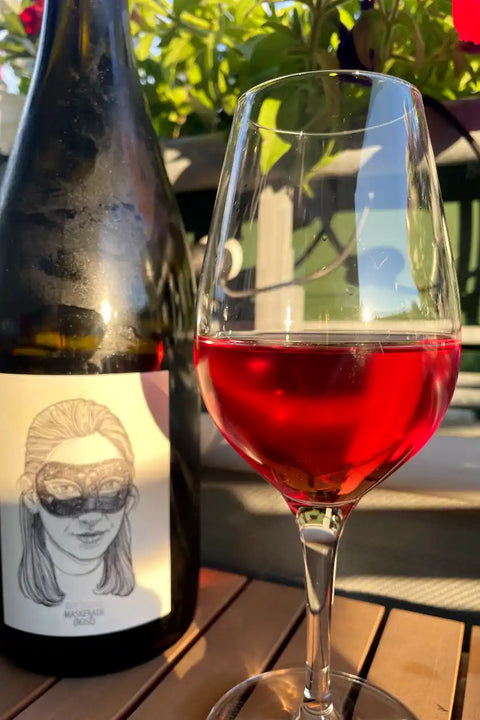 Gut Oggau Maskerade Rosé 2023 bottle and glass - Natural Wine Dealers